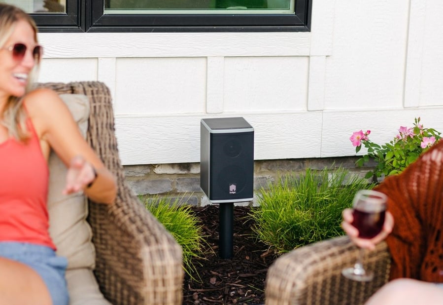 People enjoy themselves outdoors while listening to music on a Lodge Solar Powered Speaker.