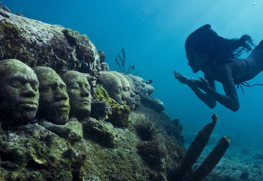 A row of head sculptures forms the beginnings of a new reef at MUSA