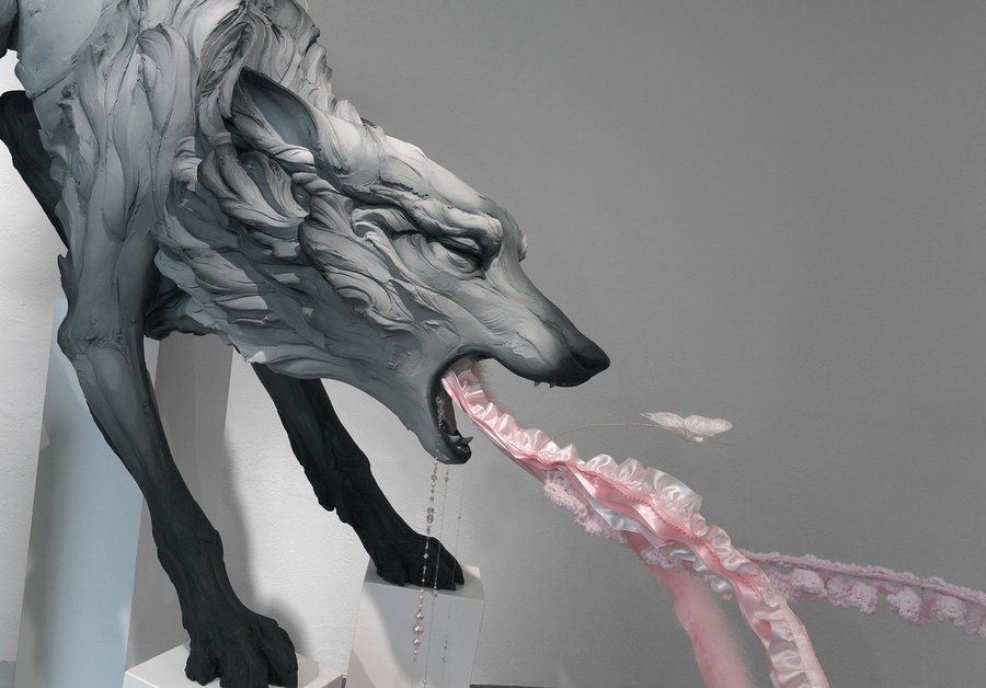 Close-up shot of an unsettlingly abstract sculpture of what looks like a wolf vomiting its intestines out. 