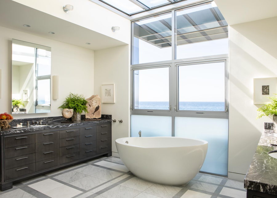 The spacious white bathroom inside the metallic Malibu beach house.