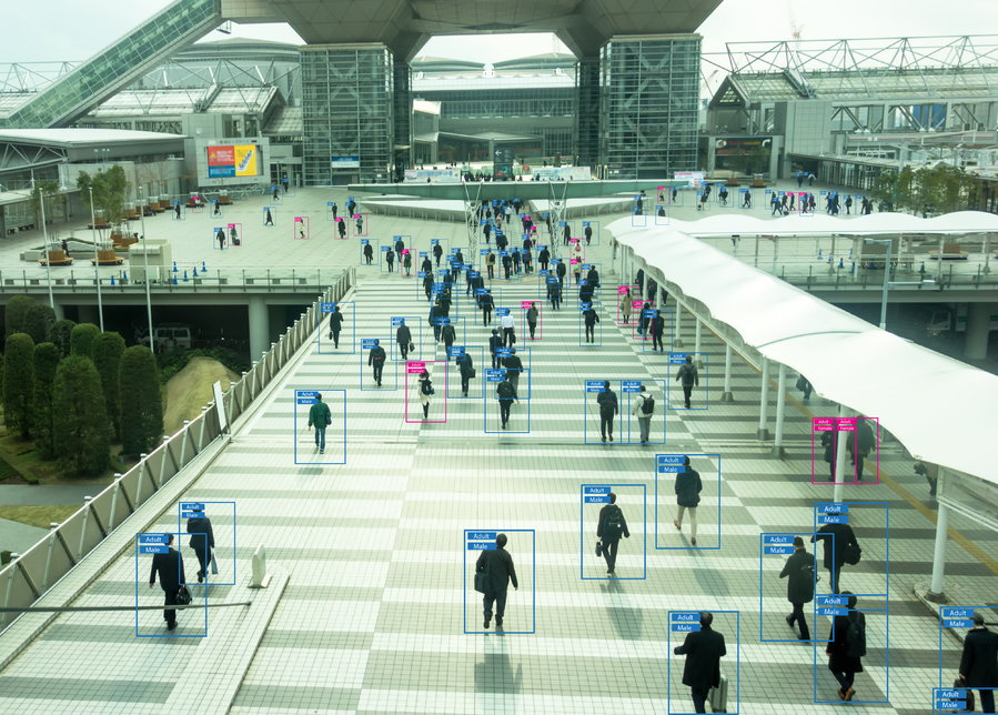 Advanced surveillance software monitors individuals as they walk through an airport terminal. 