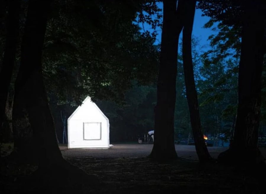 Air Architecture's white inflatable tent glows in the night.