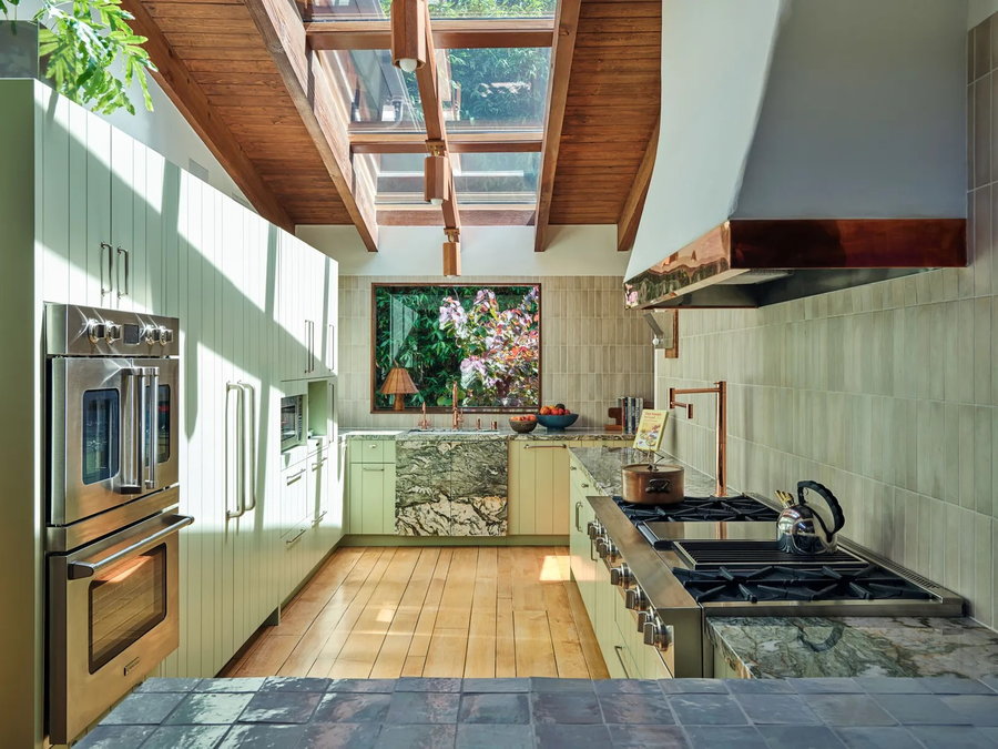 Calming green kitchen space inside social media influencer Emma Chamberlain's LA home.