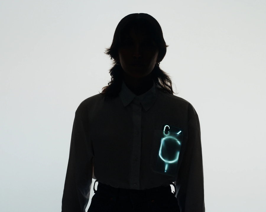 Nothing Phone (1) glows through a person's clothing. 