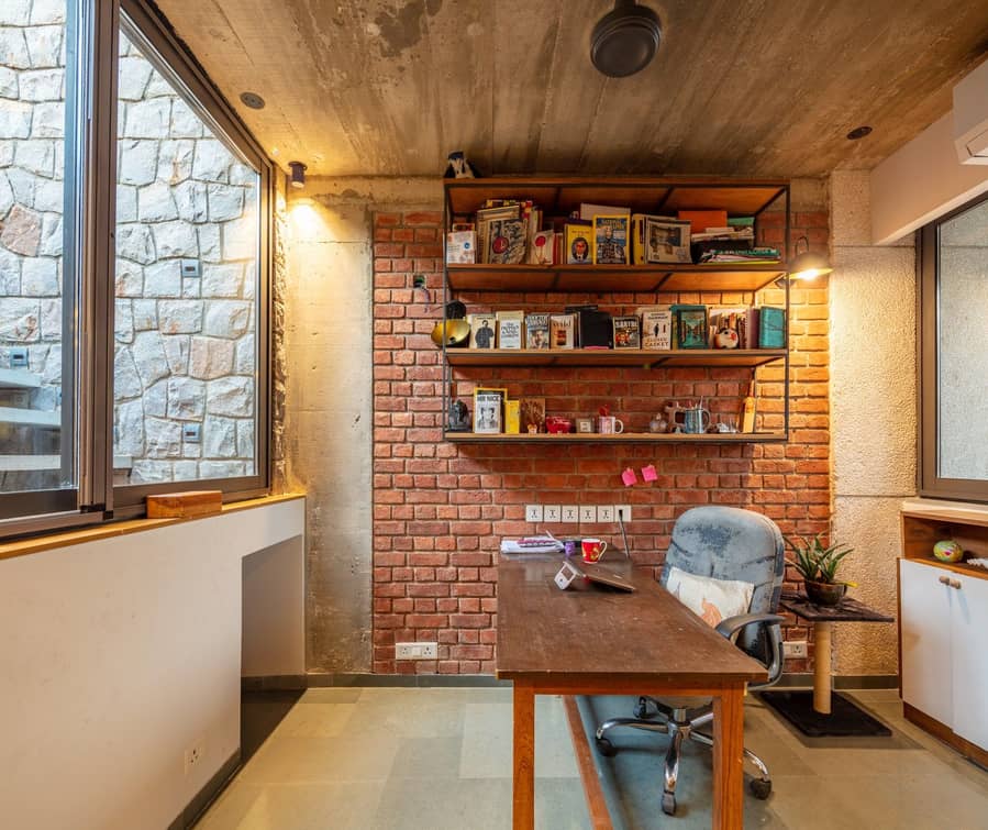 Cozy, well-lit office area inside AKDA's Louis Khan-inspired brick apartment building in New Delhi.