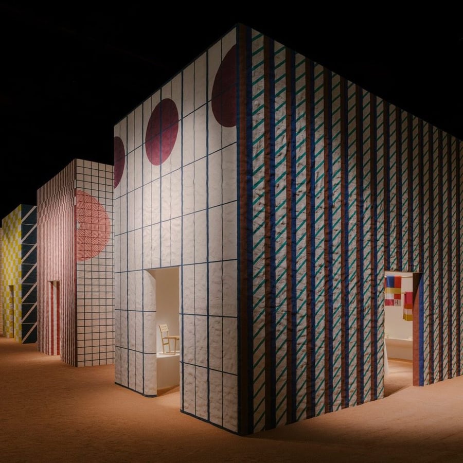 Bold geometric patterns printed on the side of a building in Hermès ' Milan Design Week display. 