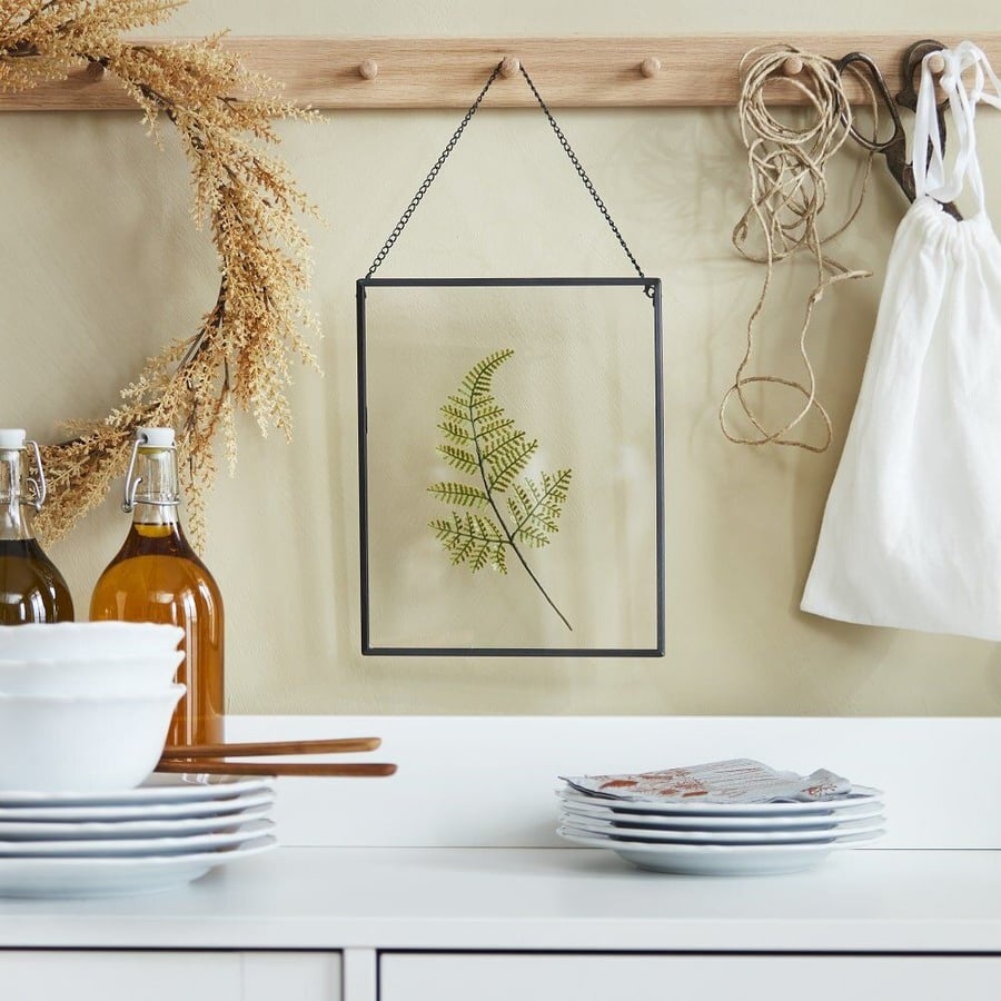 Framed fern leaf featured in IKEA's fall 2021 Höstkvall collection.