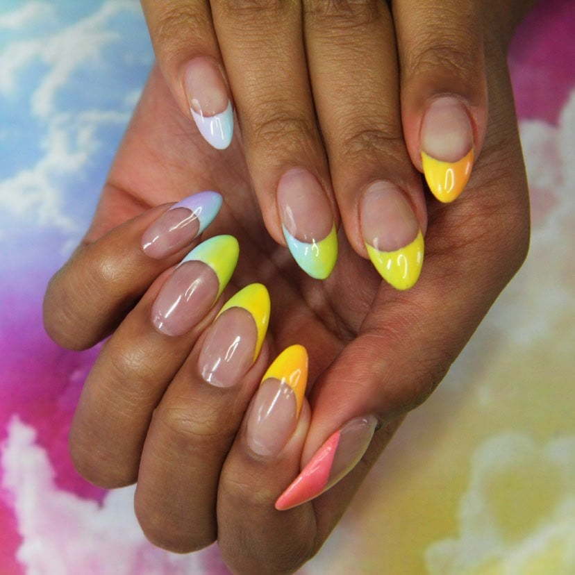 Rainbow-infused French tip nail art.