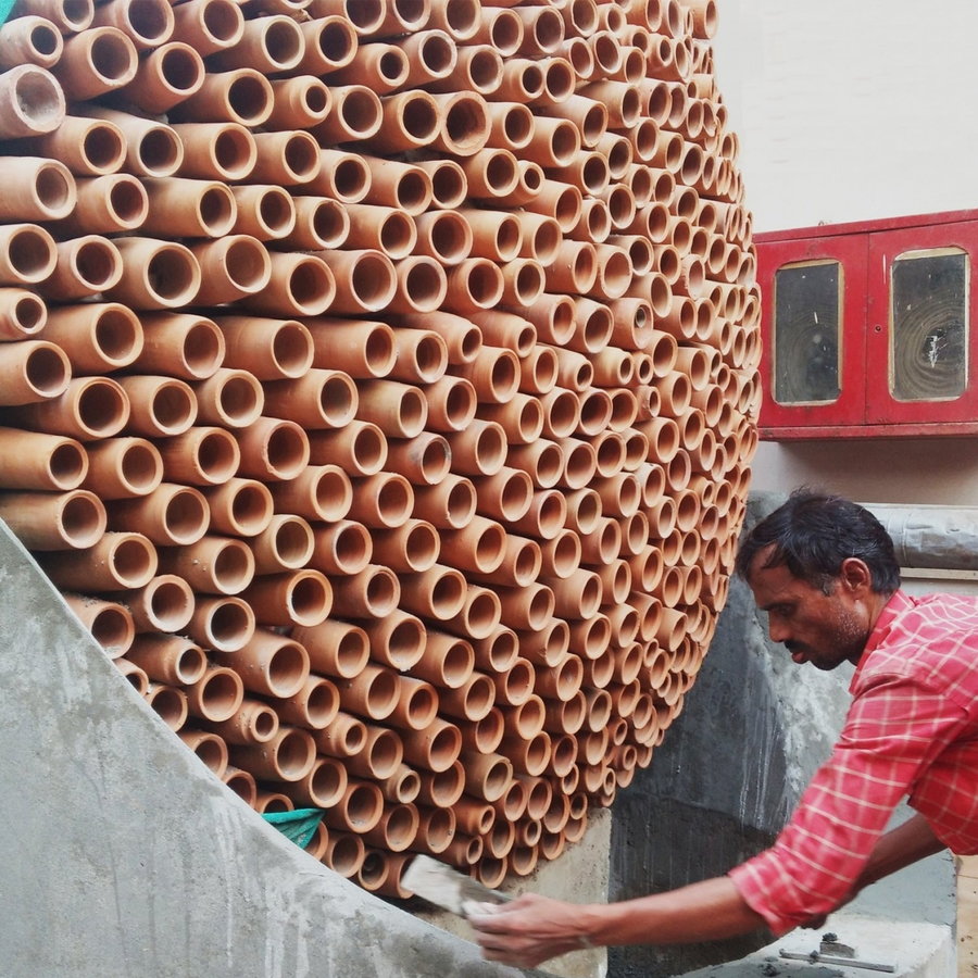 Indian craftsman assembles the Beehive evaporative cooling structure.