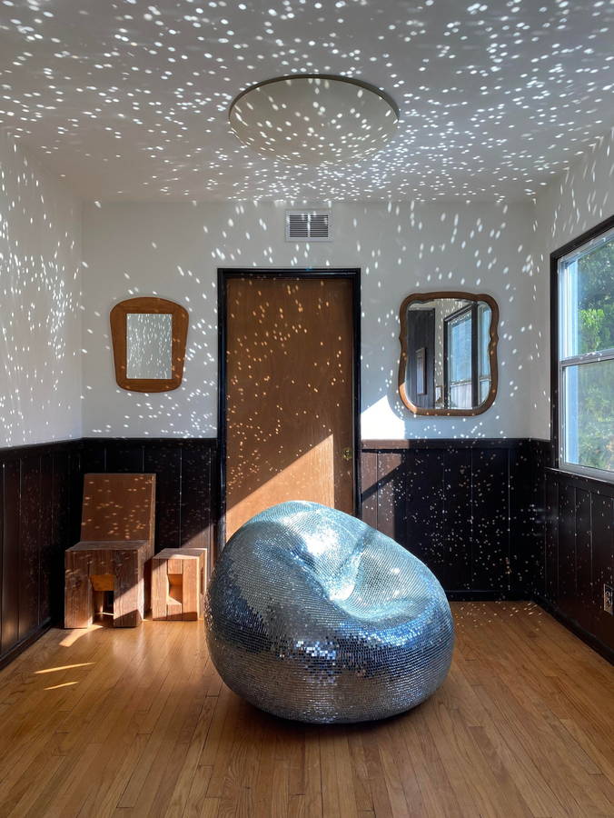 Dented disco ball beanbag lights up the room its in from the floor up.