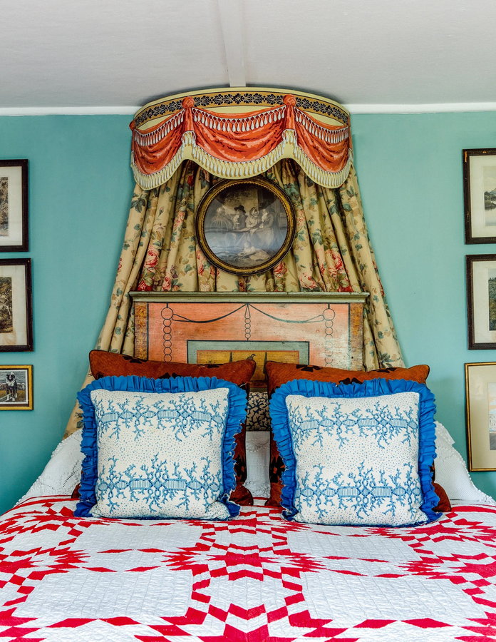 Plastered wallpaper border forms an ornate crown for this bed.
