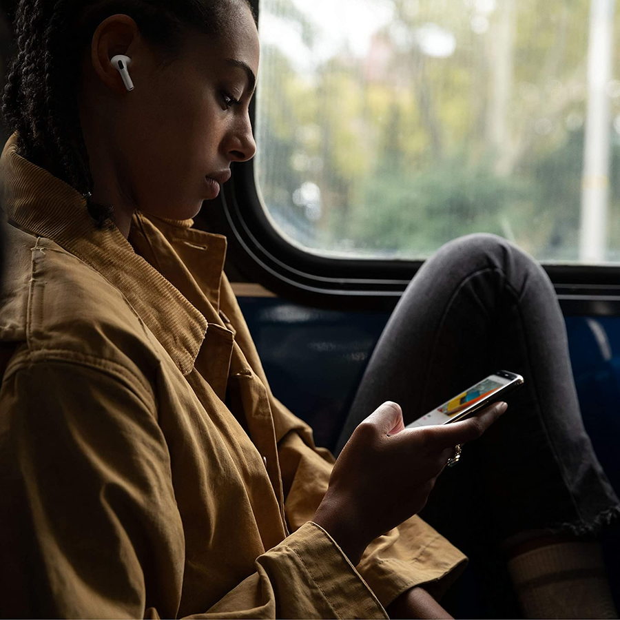 Young woman listens to music on her Apple AirPods.