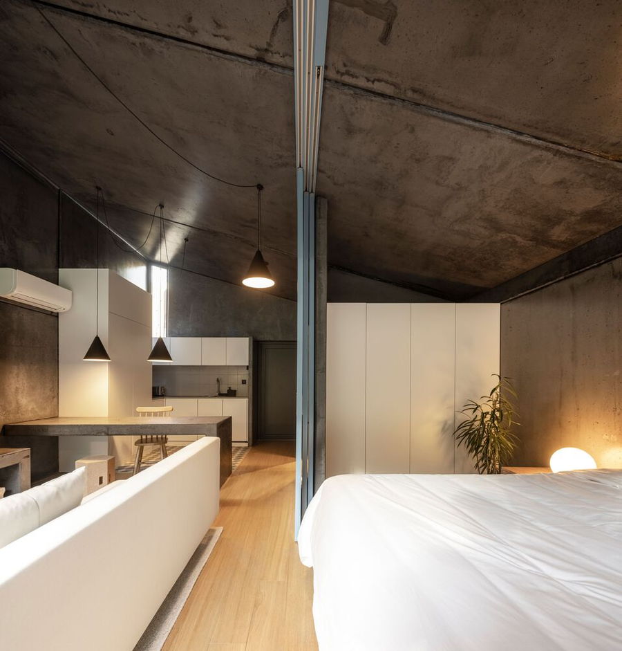 Cozy modern interiors inside the Paradinha Village Resort's modular concrete cabins.