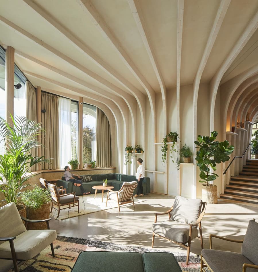 The inside of the Heatherwick-designed health center makes ample use of light wooden pieces and of course, greenery, for a totally calm and healing effect. 