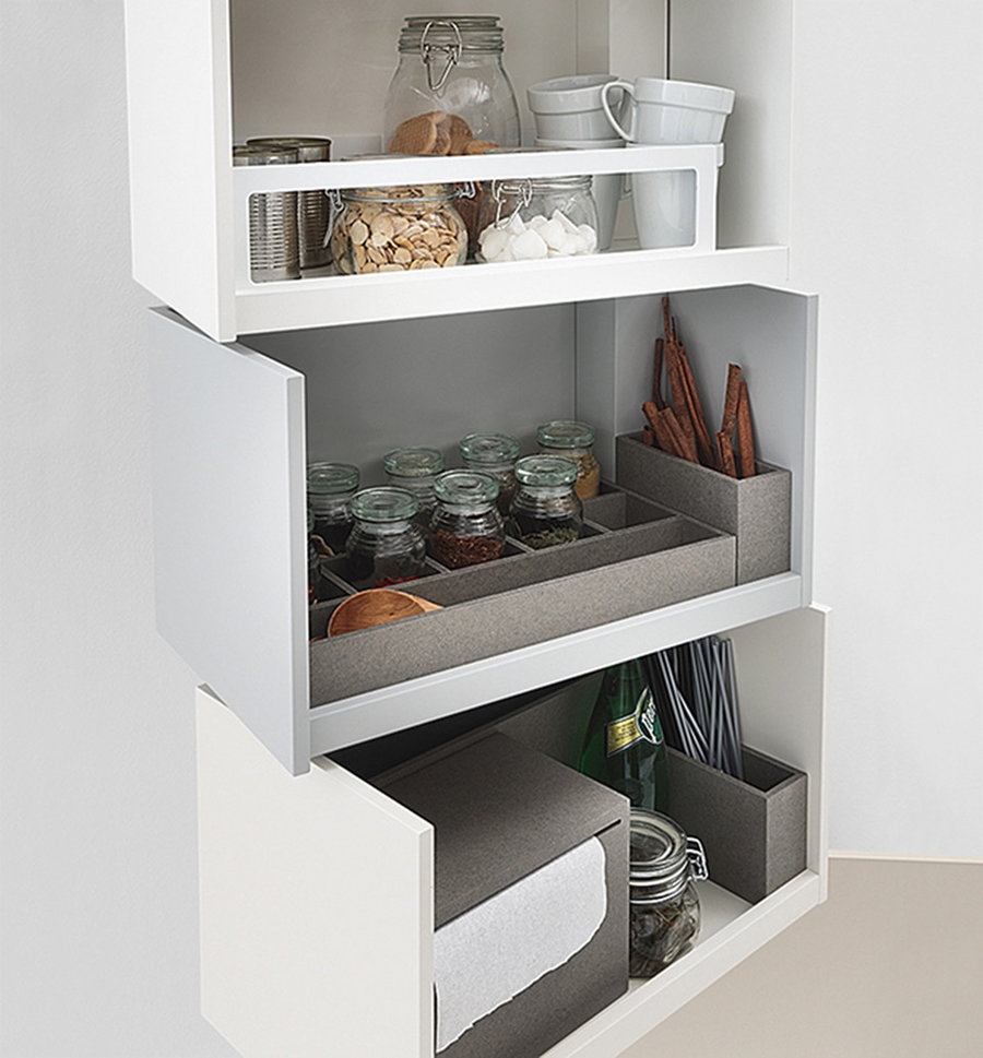 Giralot transforming storage modules hold spices and other cooking supplies in a kitchen. 