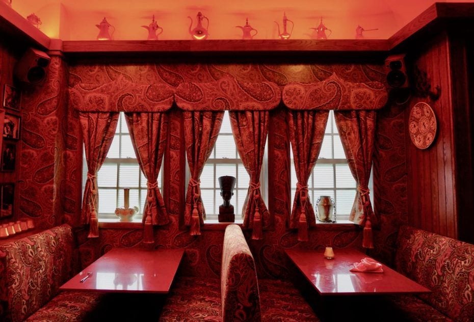Striking red wallpaper patterns dominate this room inside NYC's re-created Turk's Inn supper club.