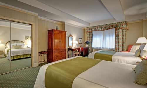 Deluxe Double room with two queen beds and is approximately 300 sq. ft at Hotel Elysee by Library Hotel Collection.