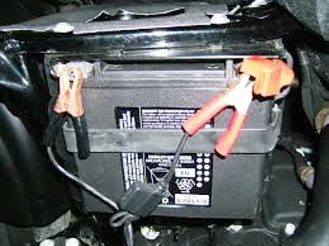 Jumper cables connected to battery terminals
