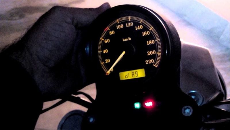 Holding the odometer button on the back of the speedometer to display the 'diag" message