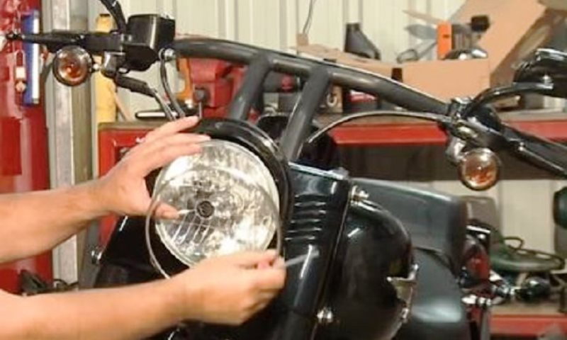 Carefully keep control of the headlamp as you remove the retaining ring