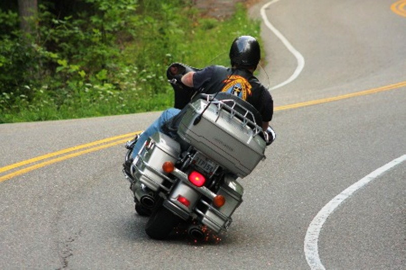 Heroic Harley corner carver throwing sparks while dragging hard parts