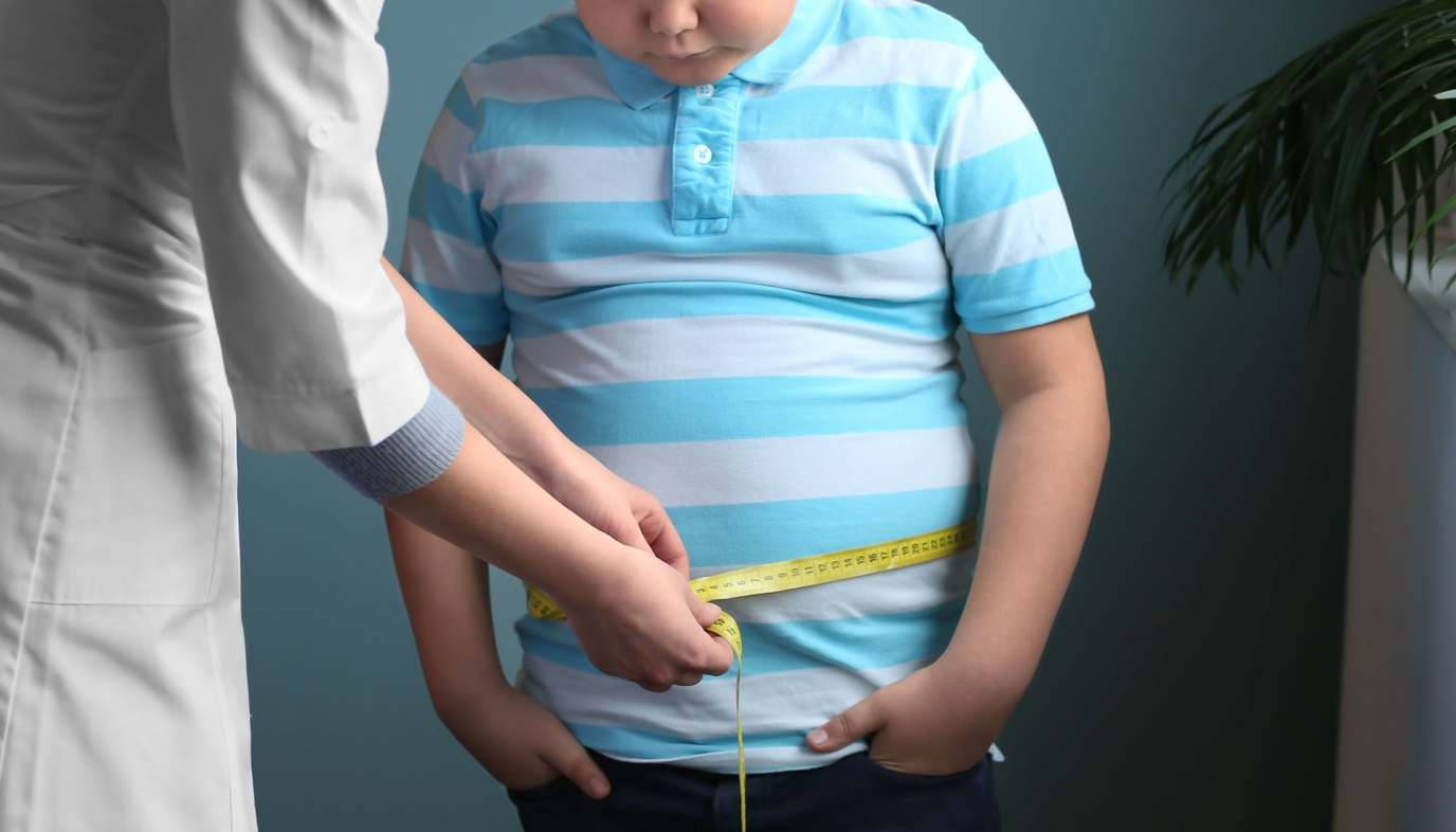 doctor measuring overweight boy