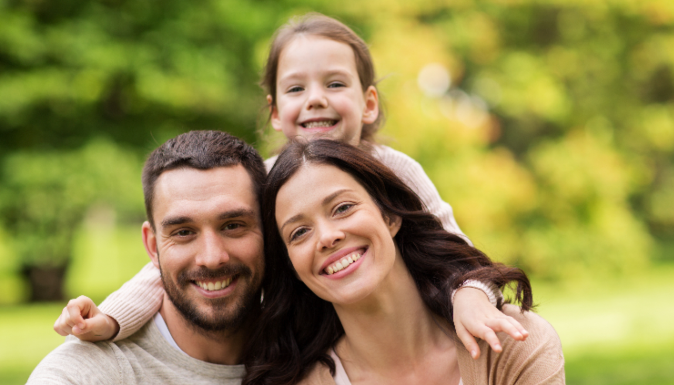 two parents and child smiling