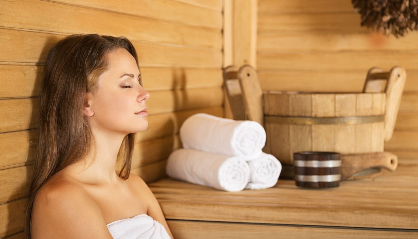 woman sitting in sauna