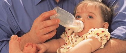 baby with bottled breast milk