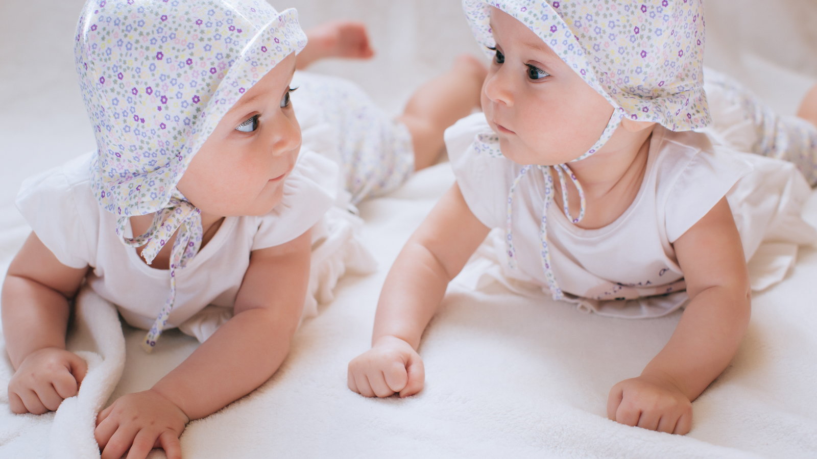 cute twin girls wearing hats