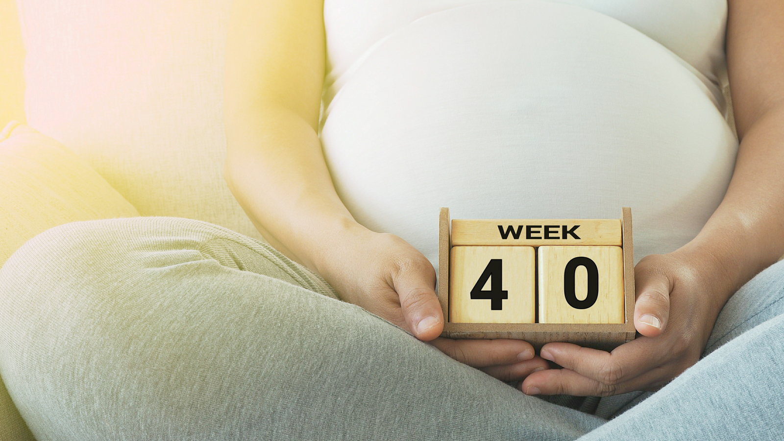 pregnant mom holding blocks that say week 40