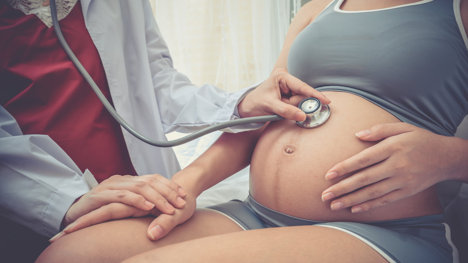 pregnant woman being checked out by doctor