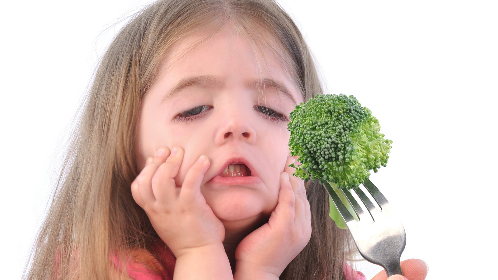girl refusing to eat brocolli