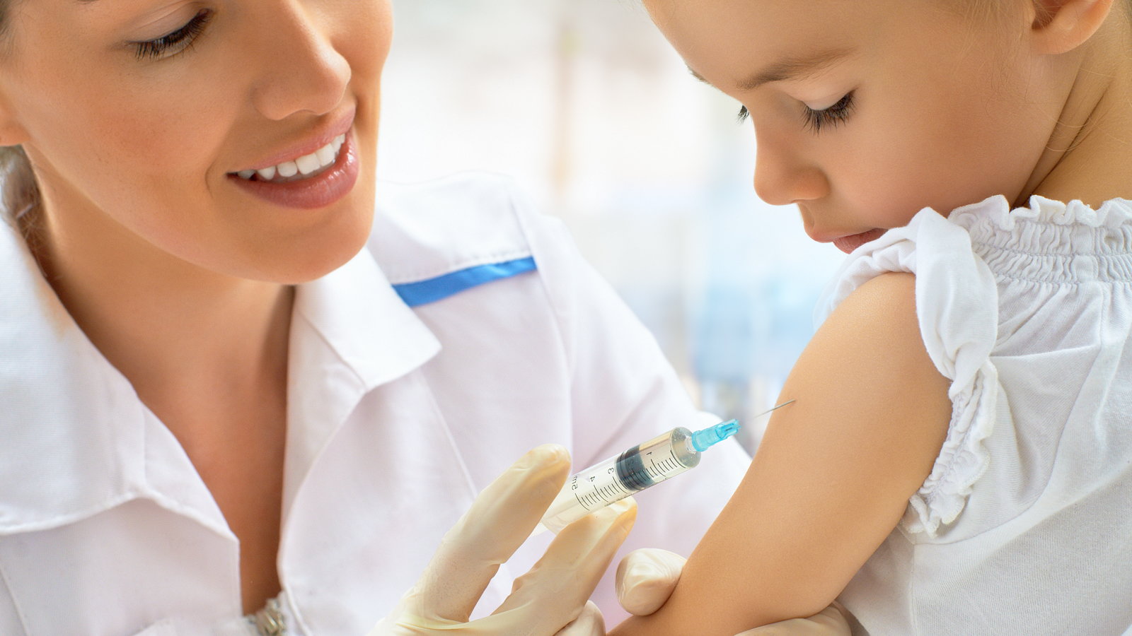 doctor giving child a vaccination