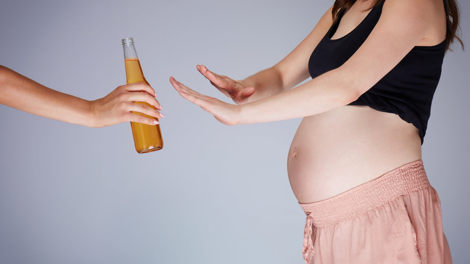 pregnant woman refusing beer