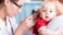 doctor looking inside baby's ear with an otoscope