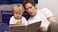dad reading bedtime story to little boy