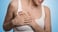 woman clutching breast from mastitis