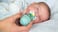 mom with bulb syringe, baby sucking on pacifier
