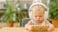 toddler wearing headset and watching video on smartphone