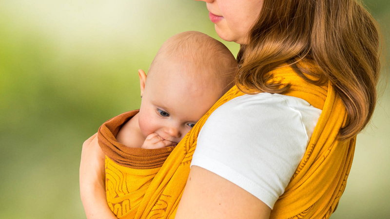 Mother holding baby in sling