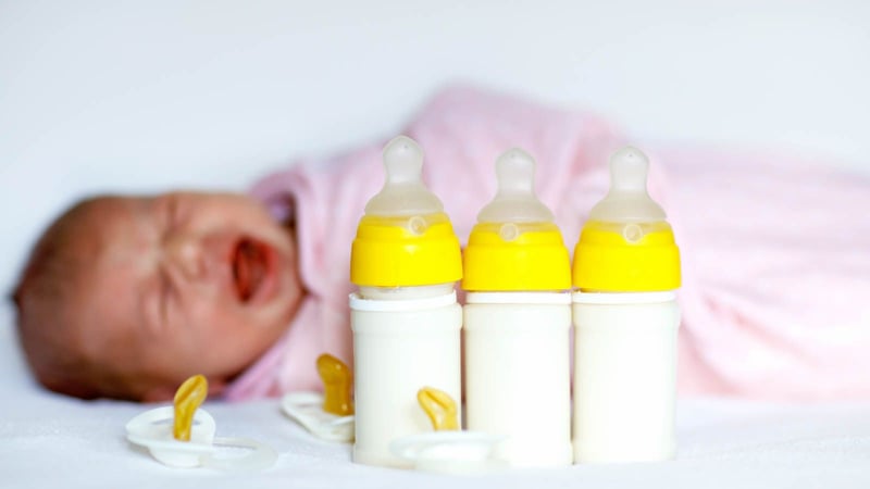 Baby crying with baby bottles