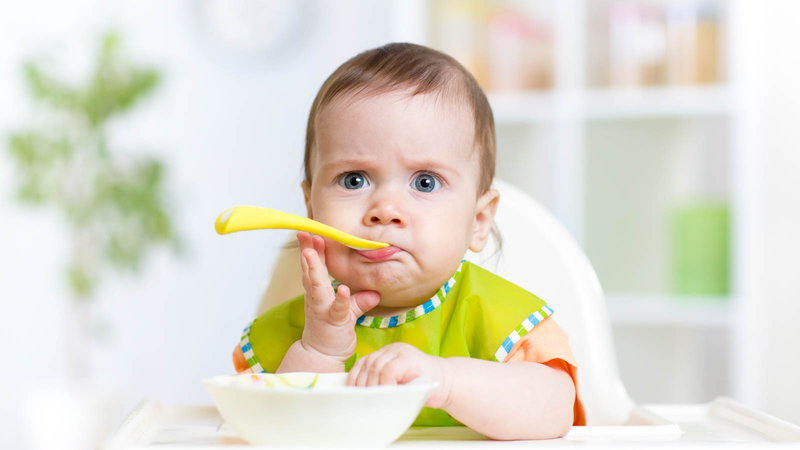 Baby eating from bowl