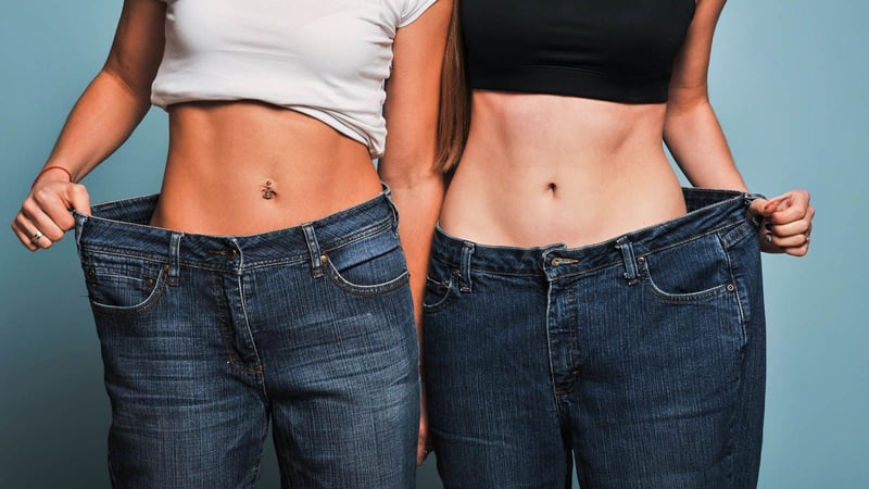 two women showing of their weightloss