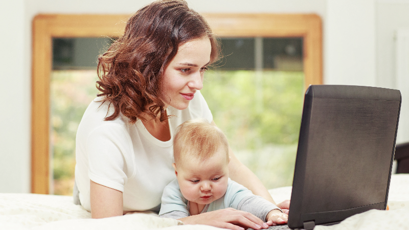 mom on laptop with baby