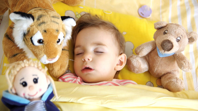 Baby sleeping with stuffed animals