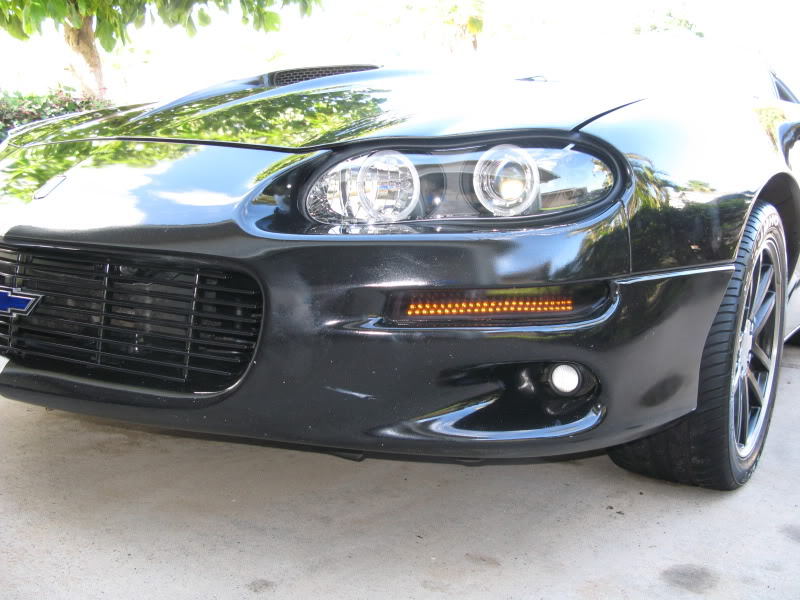 Install the turn signal housings on the car