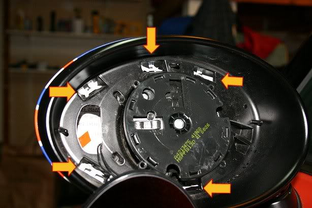 This picture shows the five clips that hold the mirror cap in place