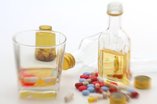 pills and open liquor bottle