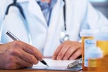 doctor writing up prescription
